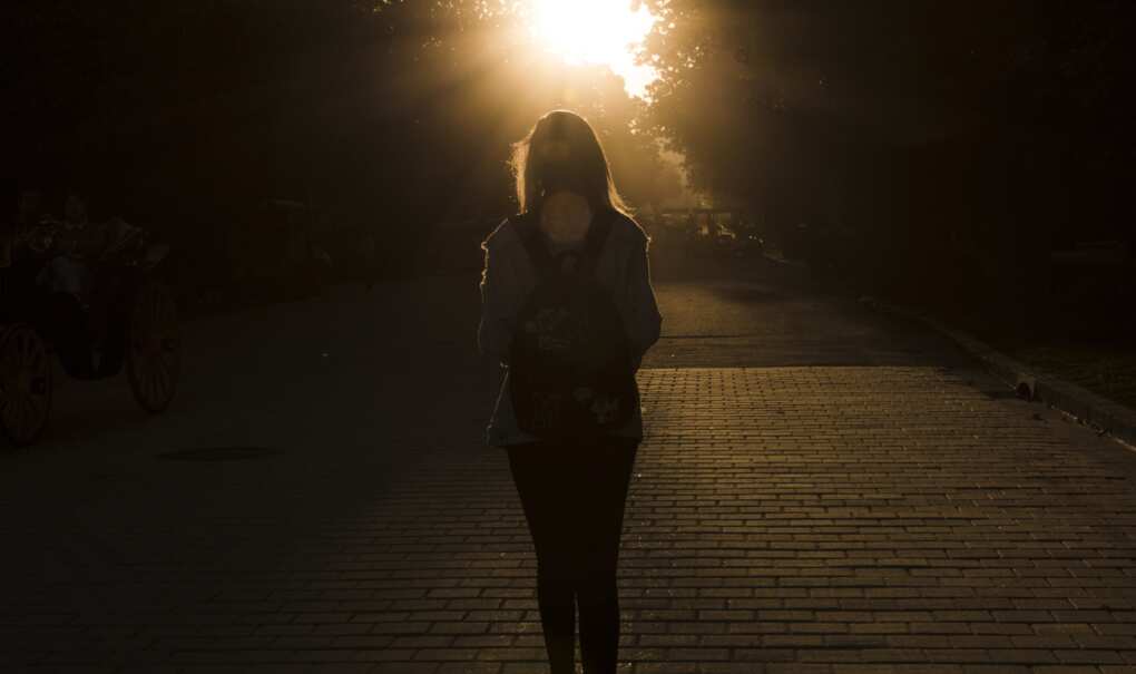 donna per strada al tramonto